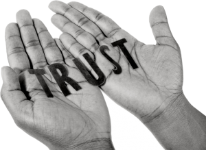 hands held out with trust written on them