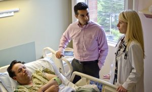 Healthcare interpreter with patient and doctor in the hospital