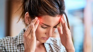 A woman with a headache because of pain points in translation